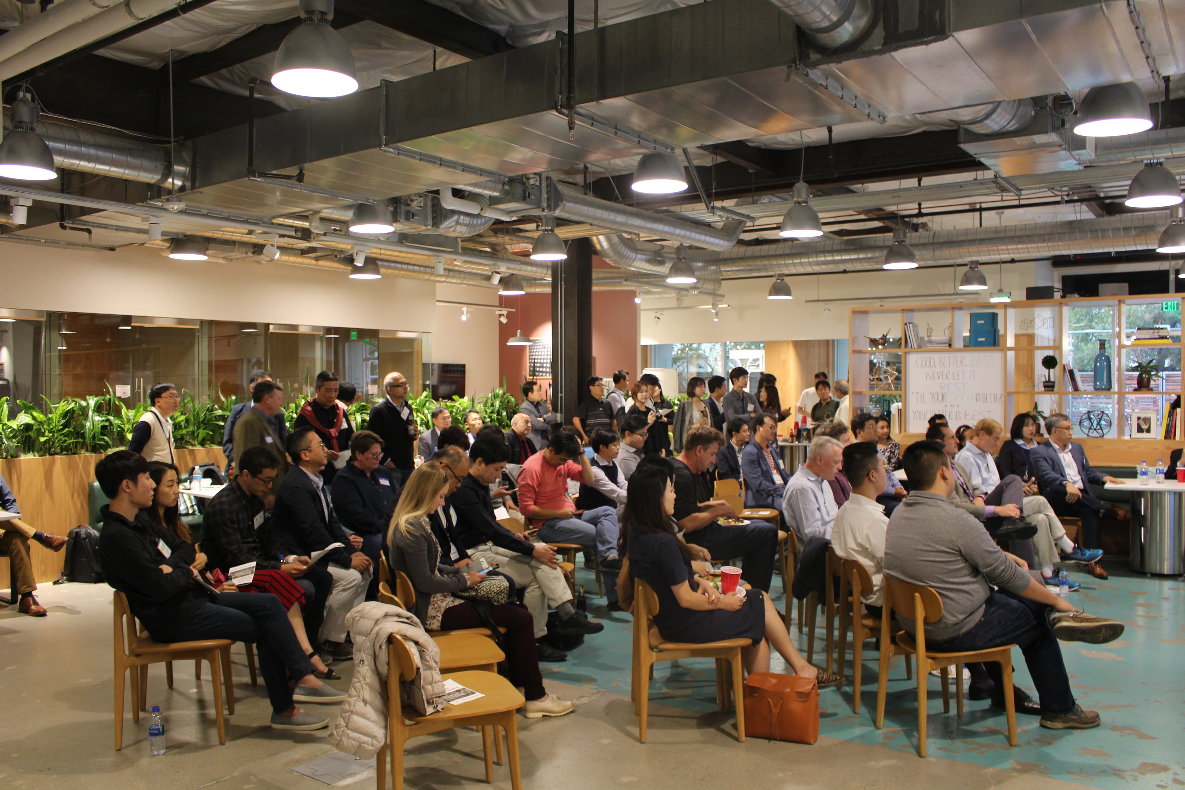 An international audience seated for a programme session in an open-plan Silicon Valley venue.